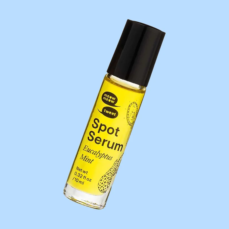 A clear bottle with a black cap, golden oil inside