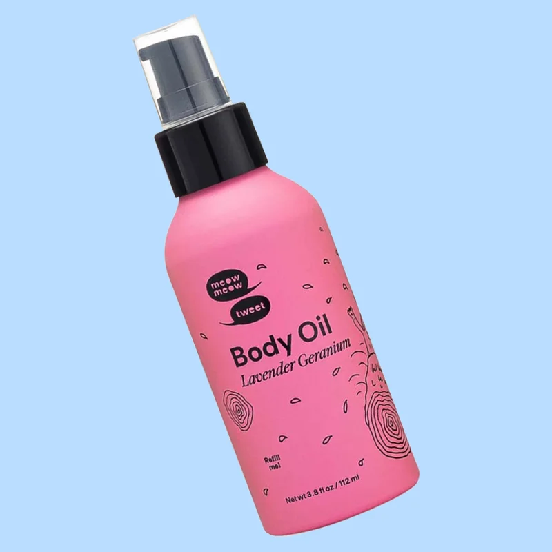 A pink bottle with a black cap