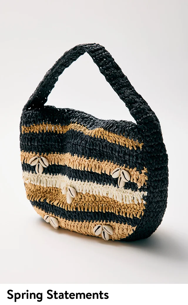 A woven clutch with black, tan and white stripes and shell accents.