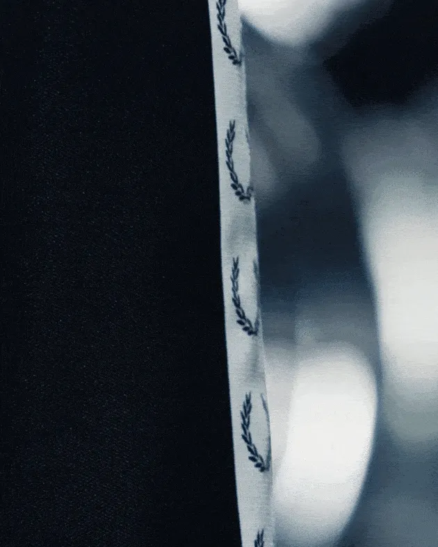 GIF of a close up of the Fred Perry Taped Track Jacket