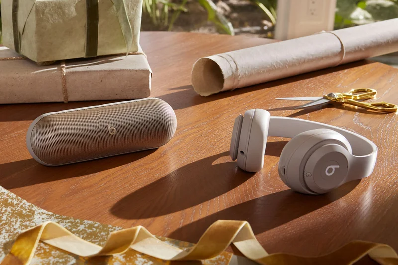 Beats Studio Pro in Sandstone and Beats Pill in Champagne Gold.
