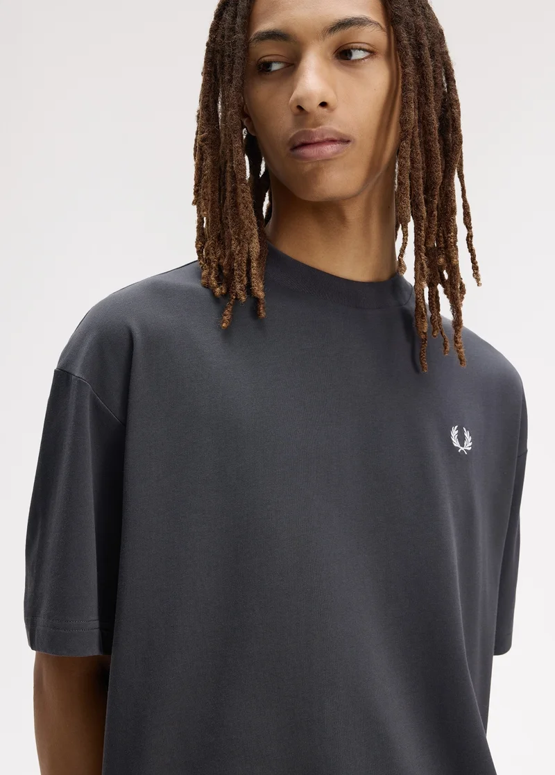 Male model wearing a Fred Perry Back Print Laurel Wreath Oversized T-Shirt in Anchor Grey