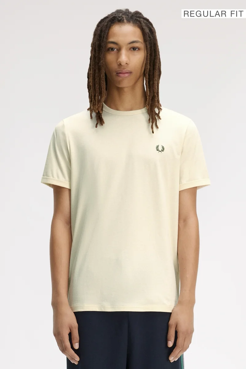 A male model wearing a Fred Perry Ringer T-Shirt in Ecru