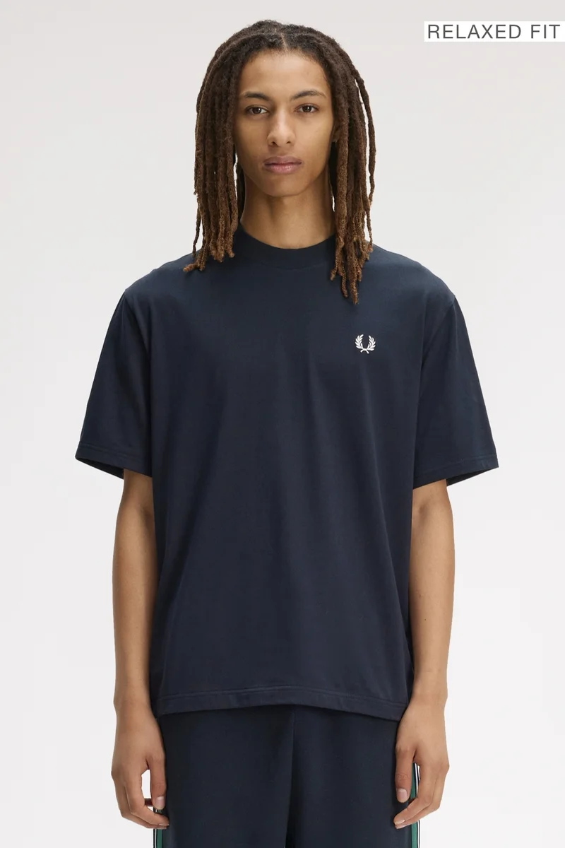 A male model wearing a Fred Perry Back Print Fred Perry Relaxed Fit T-Shirt in Navy