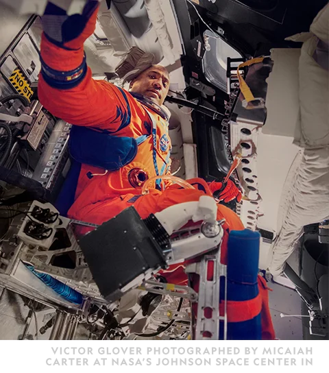 A man is in a space suit photographed in NASA's Space Center