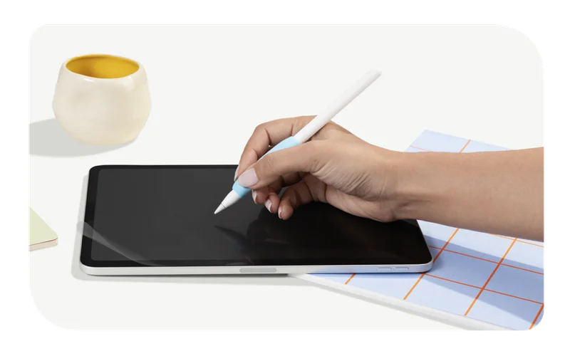 A hand holding Paperlike's Pencil Grip (2nd Generation) on top of an iPad