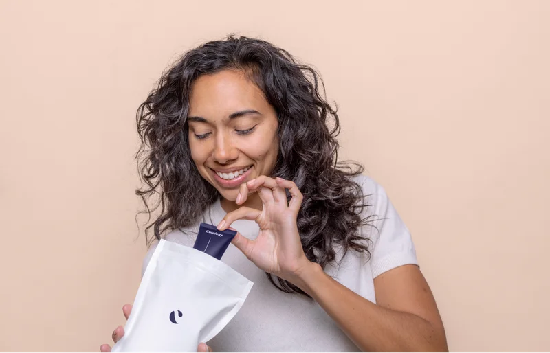 Woman opening Curology bag