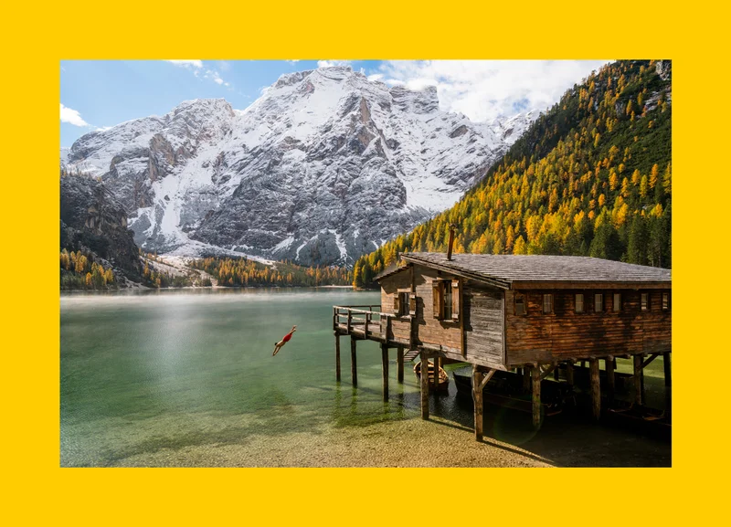 A person dives into the scenic Lago di Braies