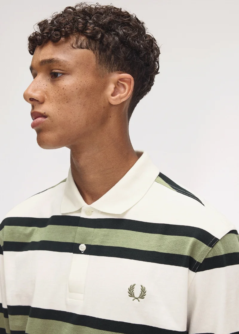 Fred Perry New Releases: black model wearing a Fred Perry Jersey Stripe Polo Shirt
