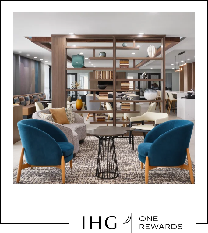 A hotel lounge area with a bar, many sitting areas, and a focal bookshelf as an accent piece in the room.
