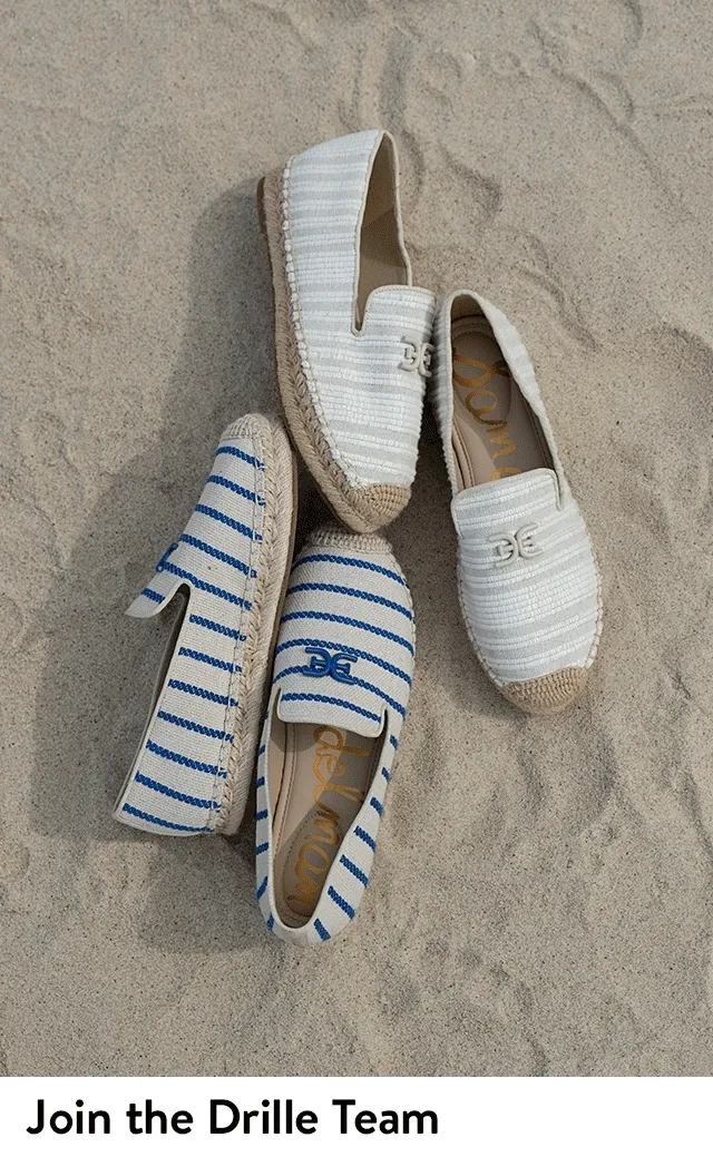 A woman wearing striped espadrilles. Espadrilles with blue and beige stripes.