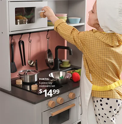 Child playing with a kitchen set