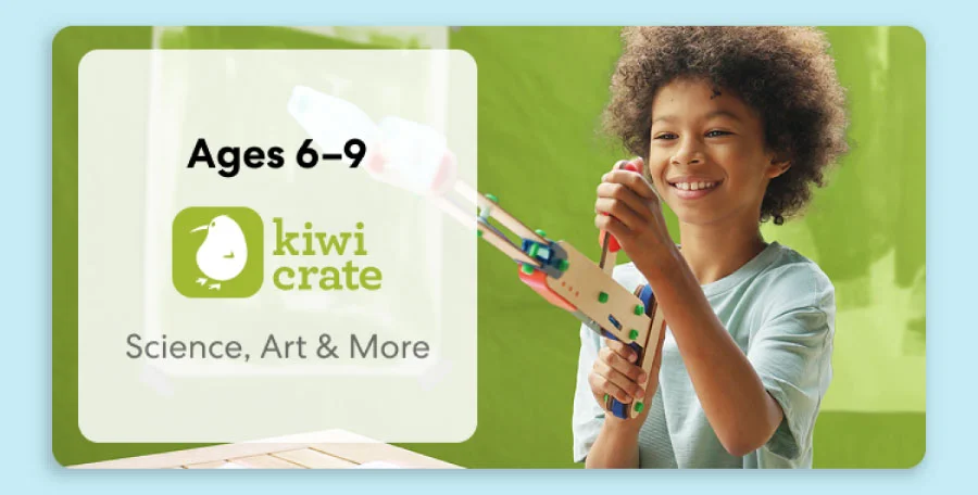 Young child smiling while working on a science experiment from KiwiCo Labs. Hands-on STEM learning for ages 6–9