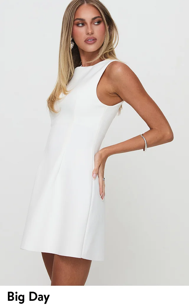 A woman wearing a white minidress.