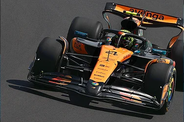 A McLaren Formula One race car speeding down a track.