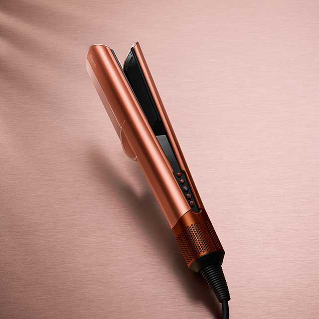 Close up of Dyson Airstrait™ straightener in Amber Silk