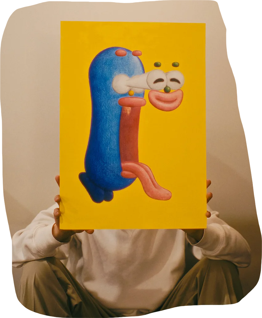 Gento holds a large yellow image of a blue bean-shaped character whose face comically pops out