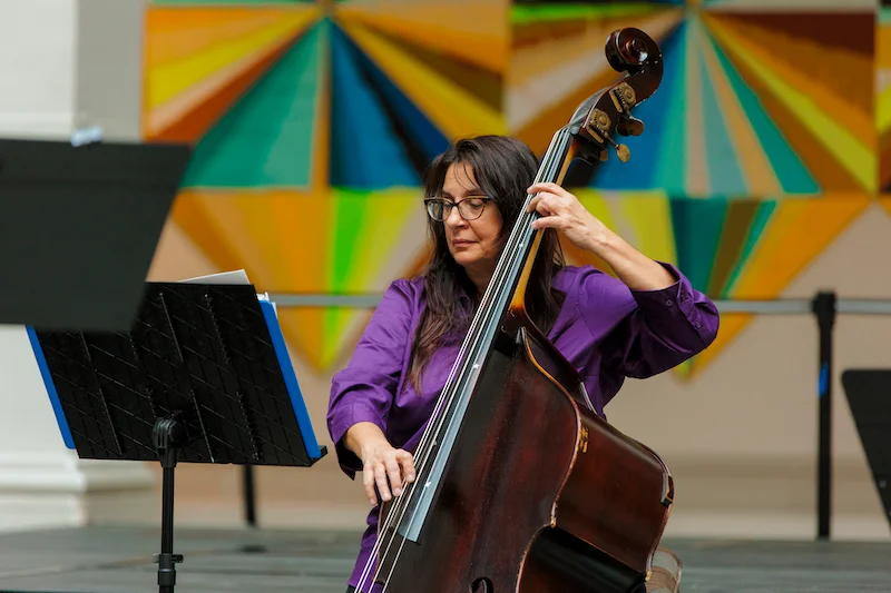 Musician performing on a cello in the Brooklyn Museum