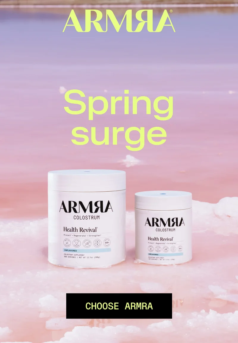 ARMRA® Spring surge CHOOSE ARMRA. Two white ARMRA Colostrum Health Revival containers (large and small) sit in pink liquid with ice-like texture, soft gradient background.