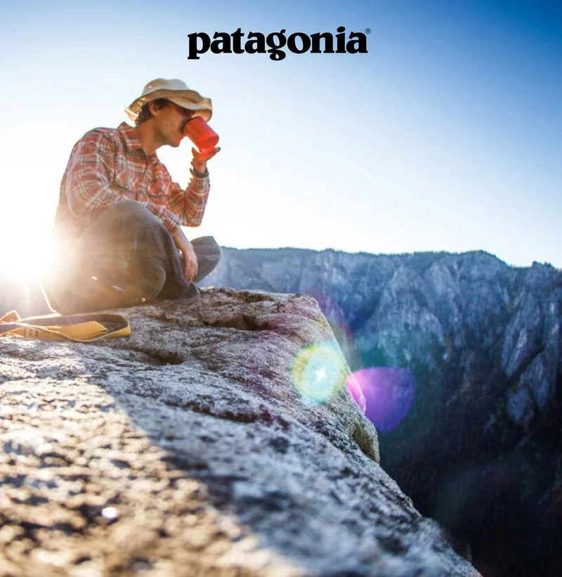 Patagonia. A person drinks from a mug on a cliffside as the sun rises.