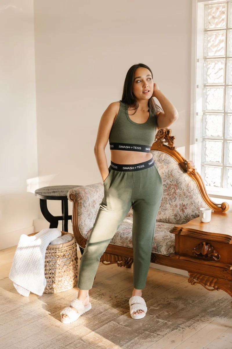 brunette wearing green crop top and jogger