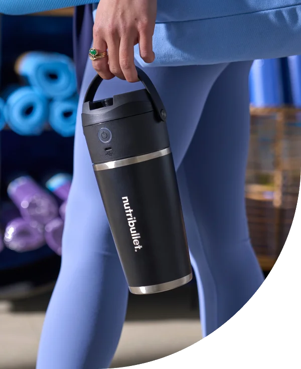 nutribullet FlipTM blender being carried by woman’s hand.