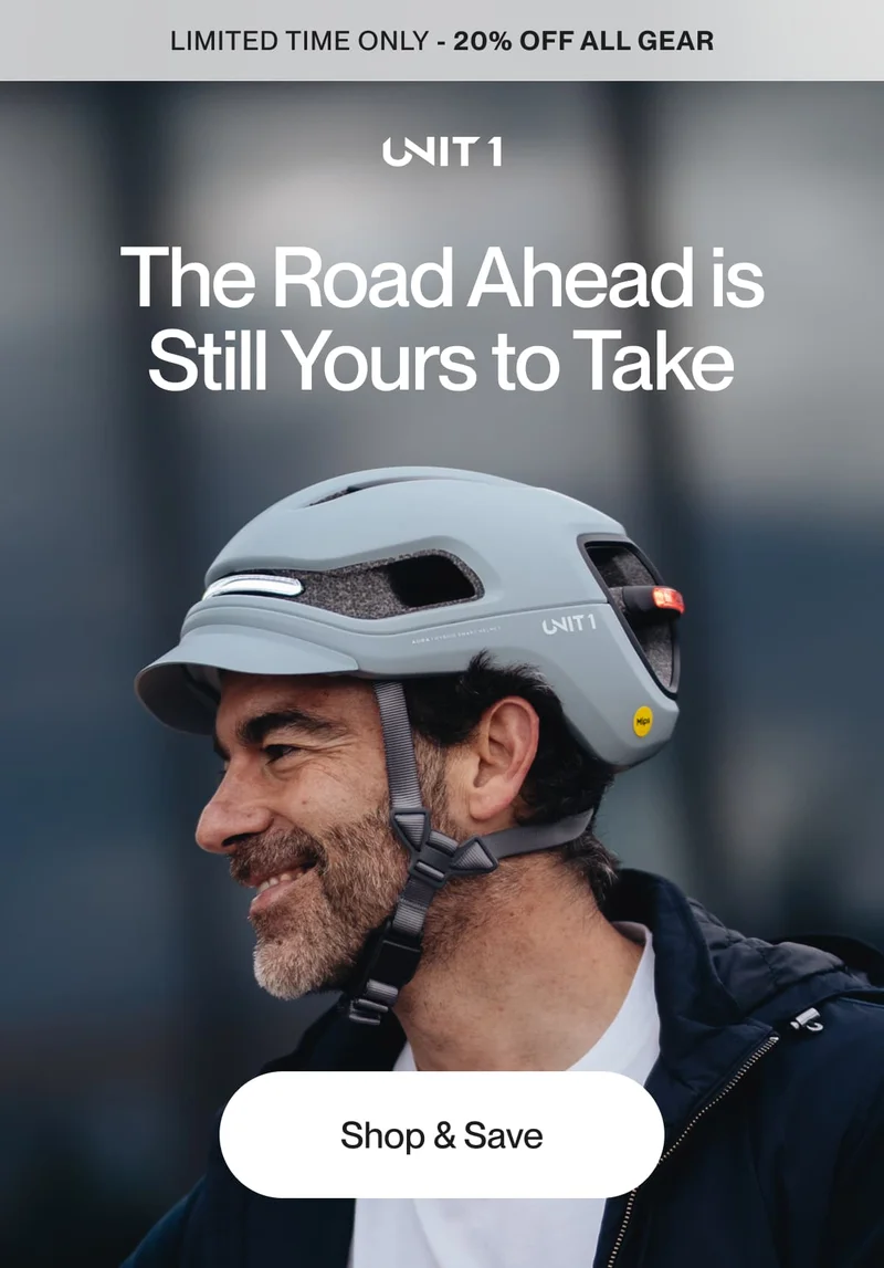 Man wearing UNIT 1 AURA helmet and smiling confidently — 20% off all gear for a limited time.