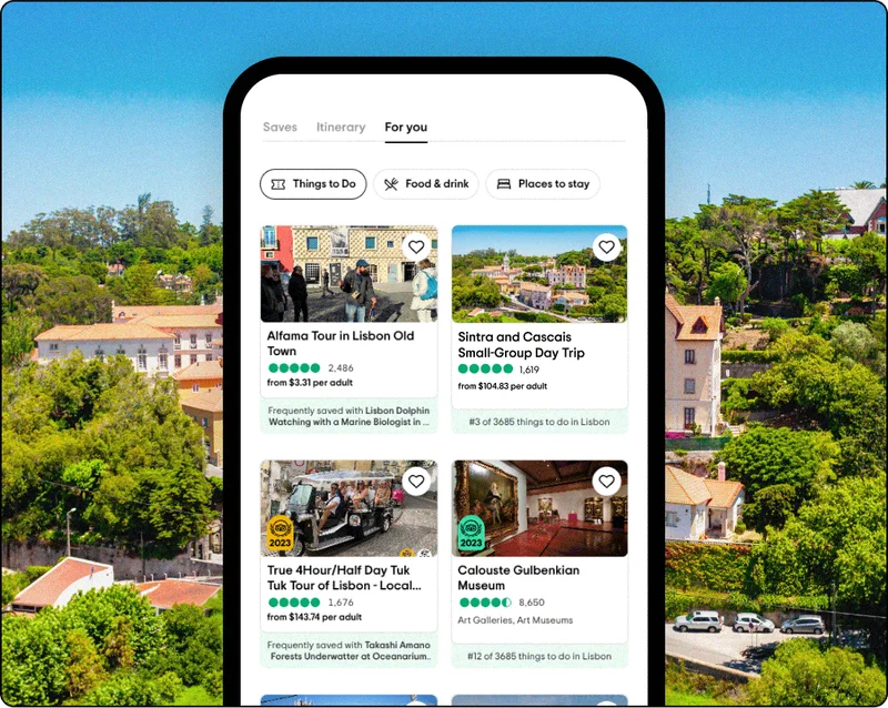 Image Description: Phone screen graphic overlaid on a scenic photo. The phone shows a person’s trip in the For You tab with recommended tours and attractions.
