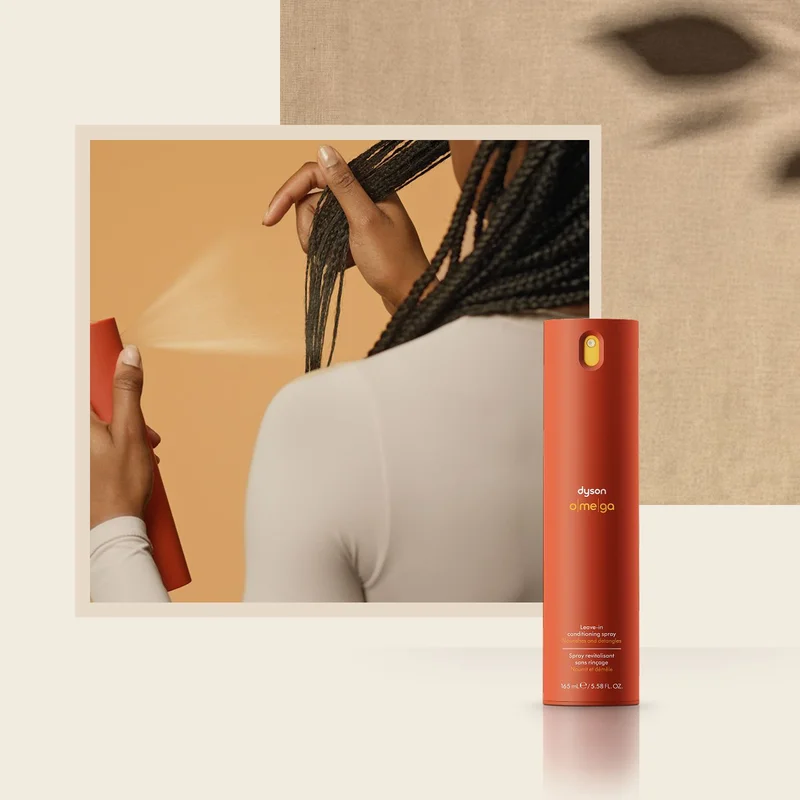 Dyson Omega leave-in conditioning spray is applied to hair.