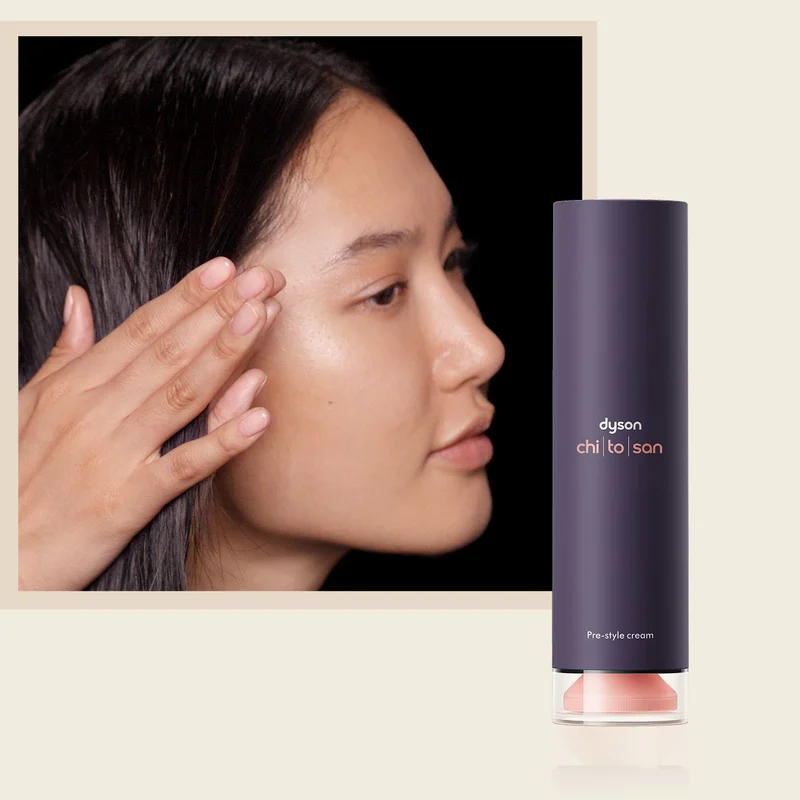 A model smooths Dyson Chitosan Pre-style cream through her hair.