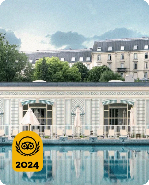 Image Description: White lounge chairs by a pool in front of a blue and white hotel. A gold 2024 Travelers’ Choice Awards Best of the Best badge is on the bottom left corner of the image.