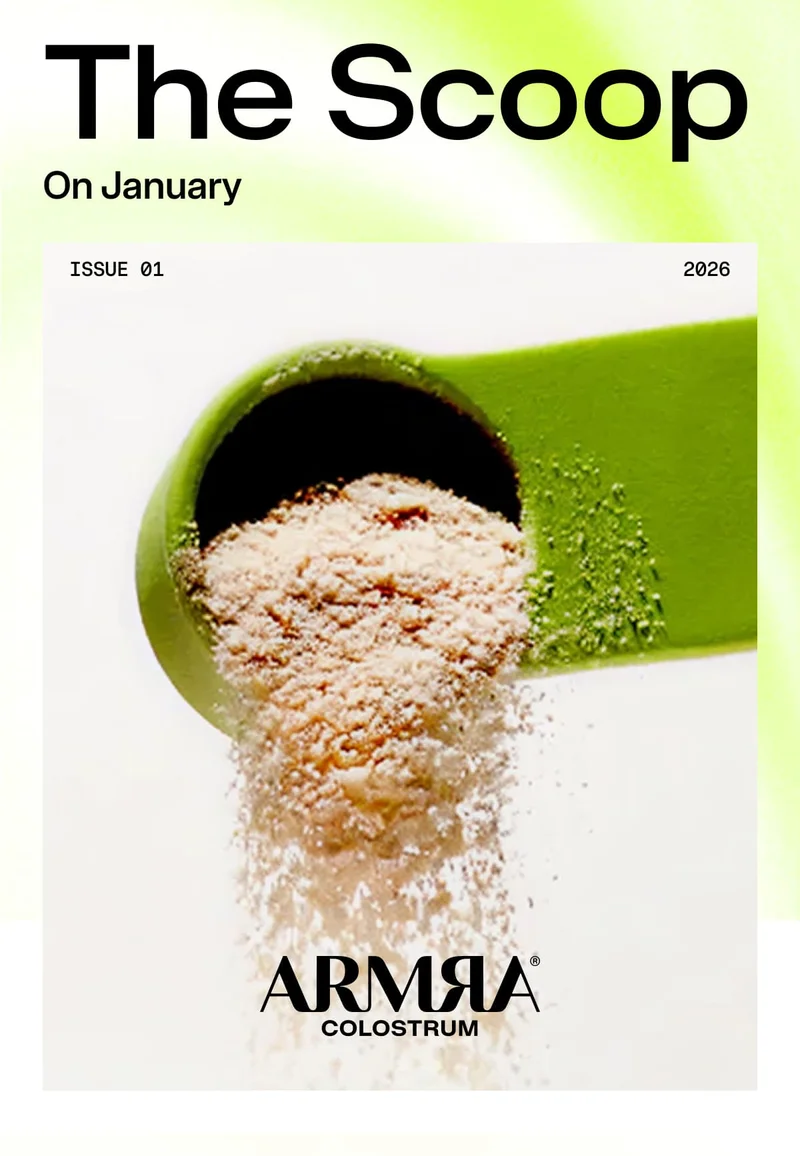 Green scoop pouring ARMRA colostrum powder beneath “The Scoop” January 2026 header.