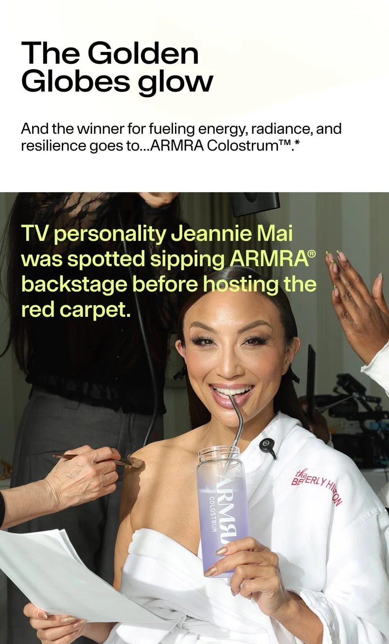 Jeannie Mai smiling backstage at the Golden Globes while sipping ARMRA Colostrum.