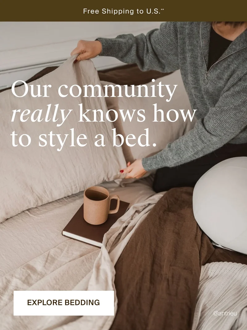 Styled shot of a woman in bed with journal and ceramic coffee mug. Explore bedding.