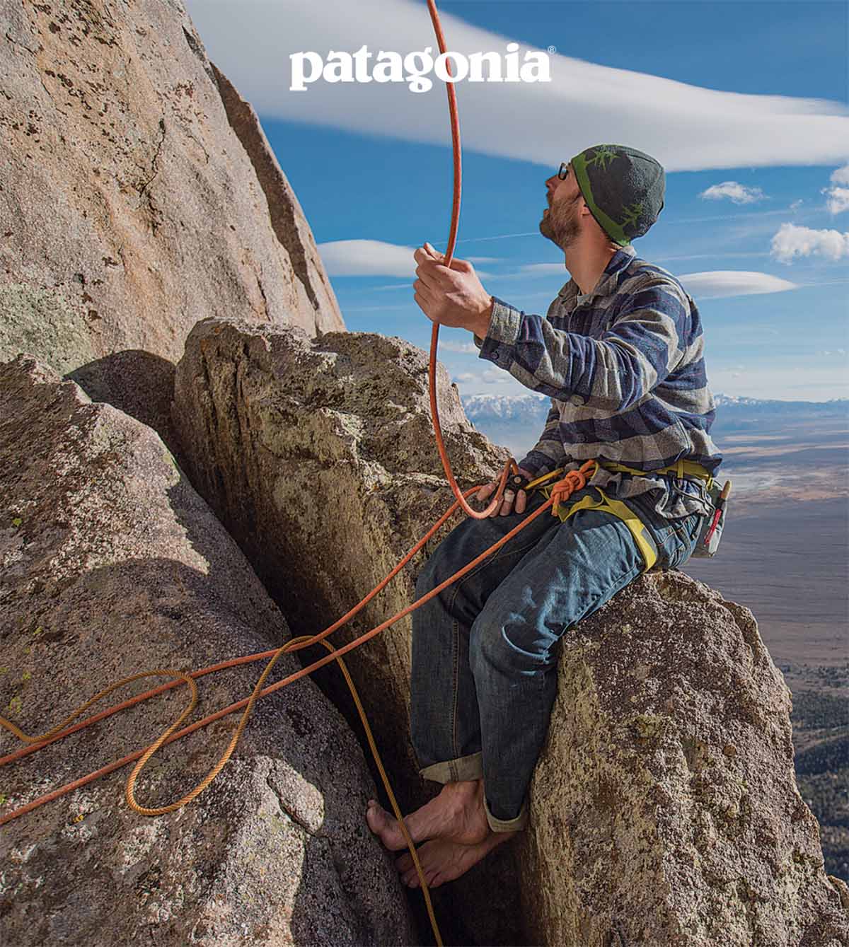 Patagonia. A person belays a climber overhead.