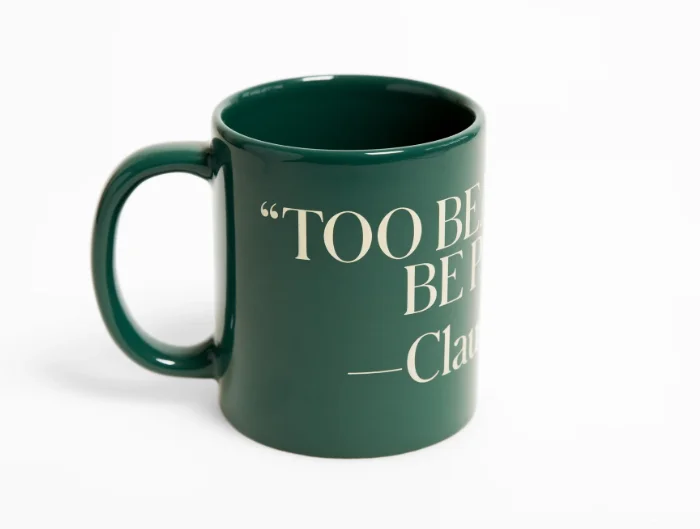 A green mug that reads "Too beautiful to be painted." —Claude Monet