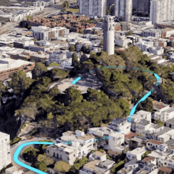 An overhead view of a city with a blue route line running through it.