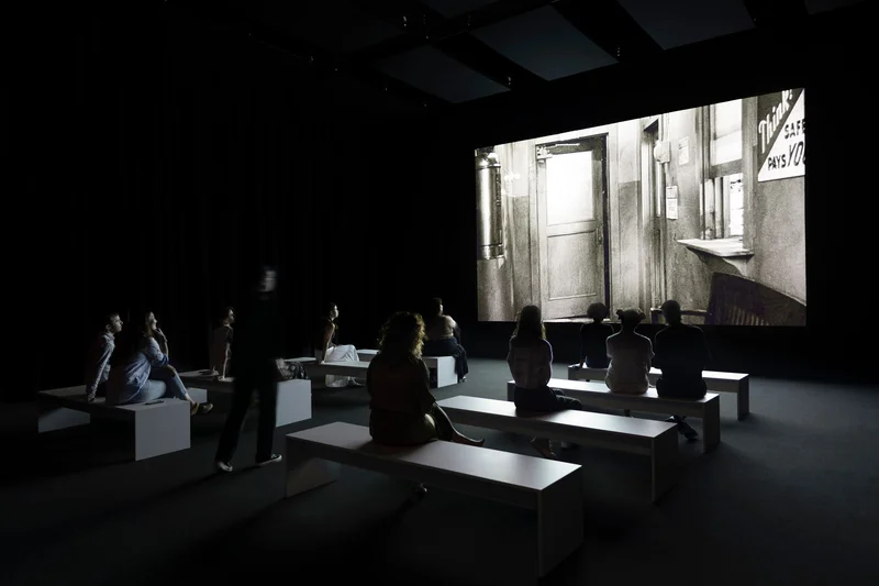 An audience watching a screen