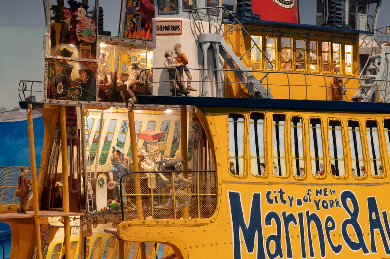 A model of a yellow boat with people on it