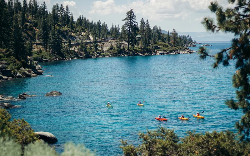 Paddle boarders on the bright blue waters of Lake Tahoe