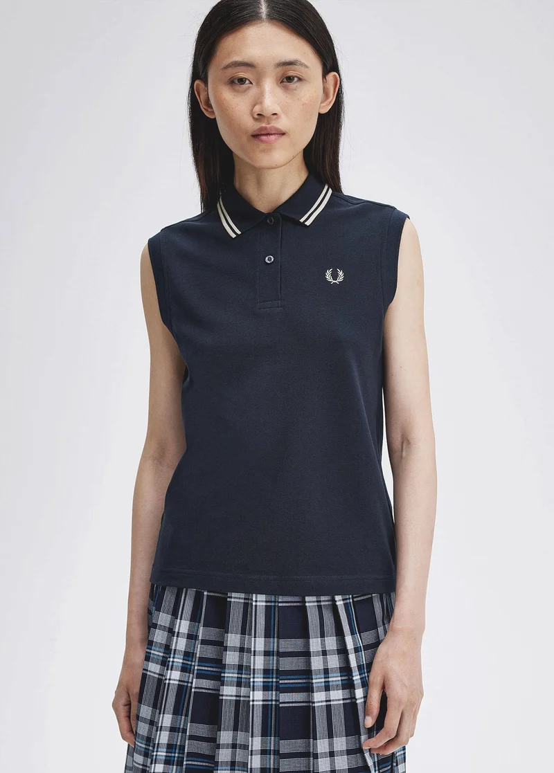 Woman wearing a sleeveless navy Fred Perry Shirt