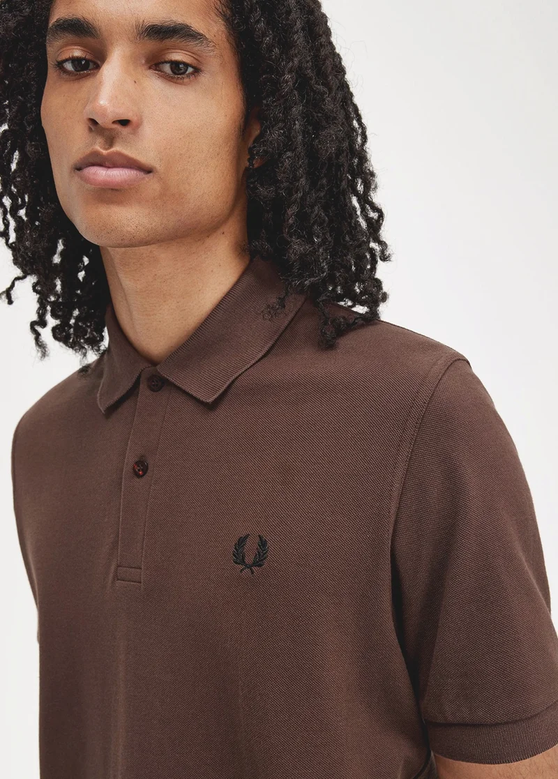 Man wearing a Fred Perry polo shirt