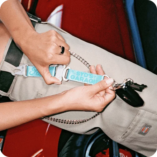A person holding a Ford x Sydney Sweeney keychain