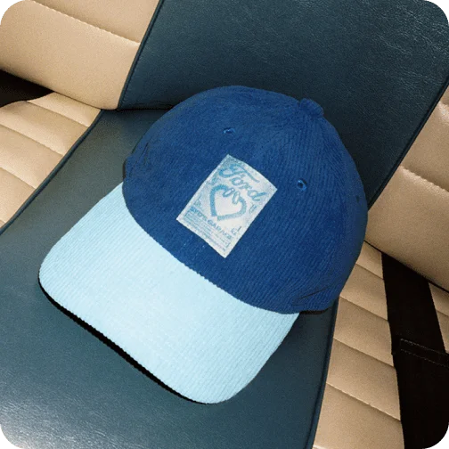 A woman wearing a Ford x Sydney Sweeney corduroy hat