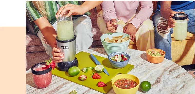 Three people enjoying snacks and making drinks in the magic bullet Mini