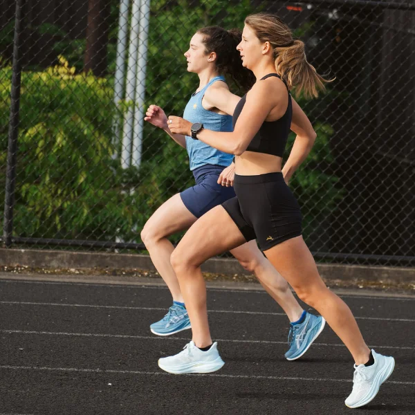 Two women running together