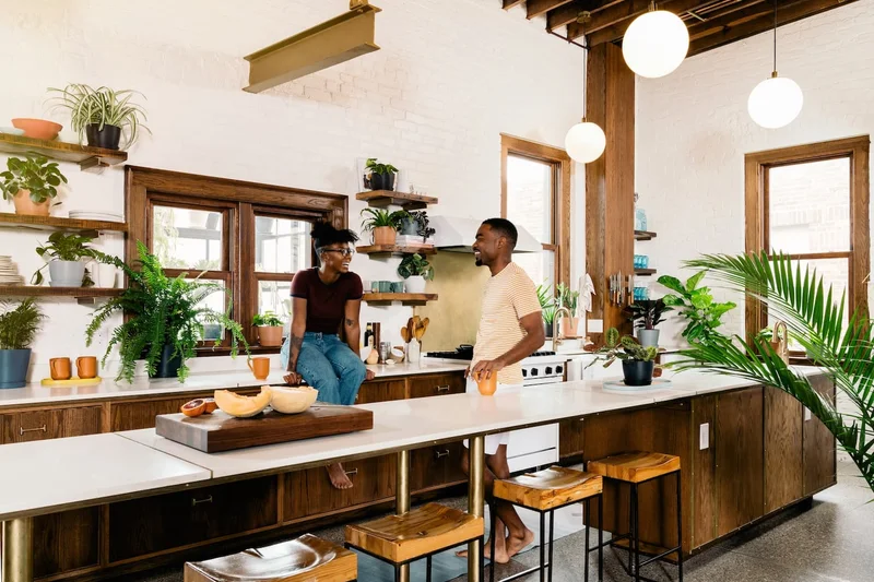 couple in kitchen surrounded by plants