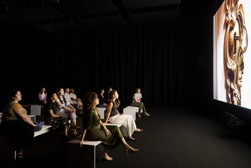 An audience staring at a screen