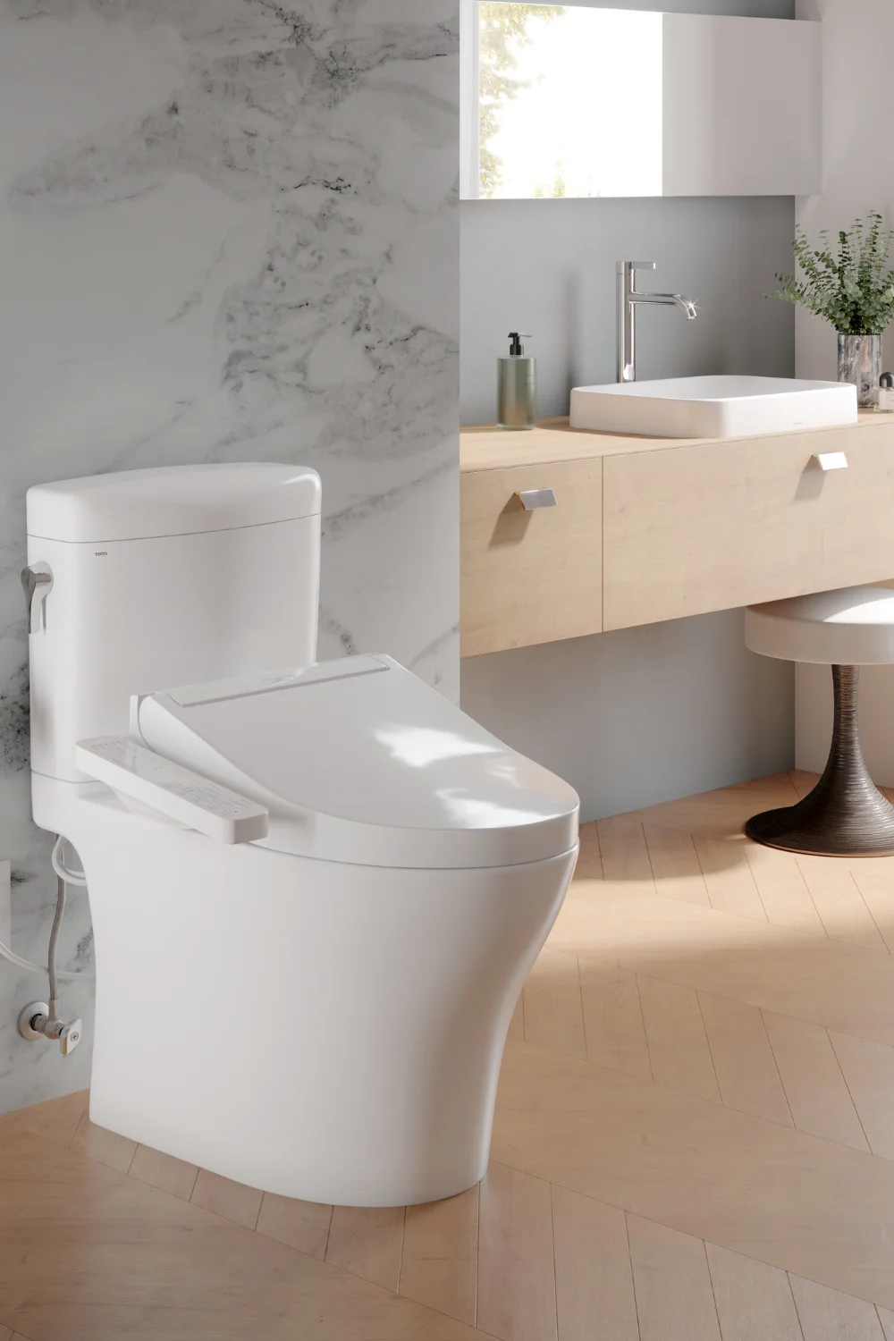 An Aquia IV toilet with a C2 WASHLET Bidet Seat attachment in a sunny, modern, bathroom