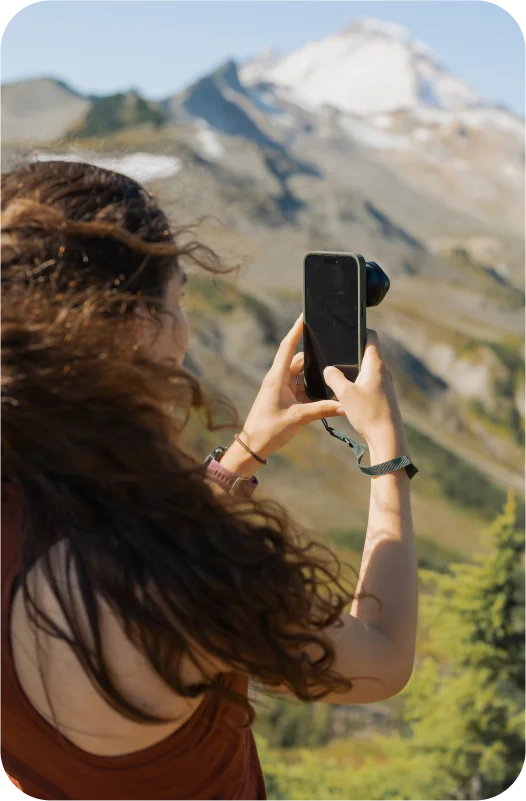 Woman taking picture of mountain with a phone